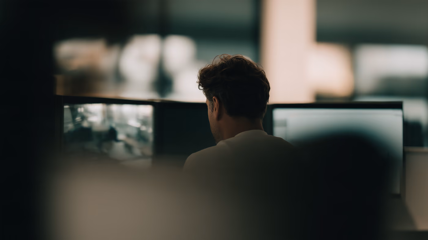 A person seen from behind against a bright, blurred interior.