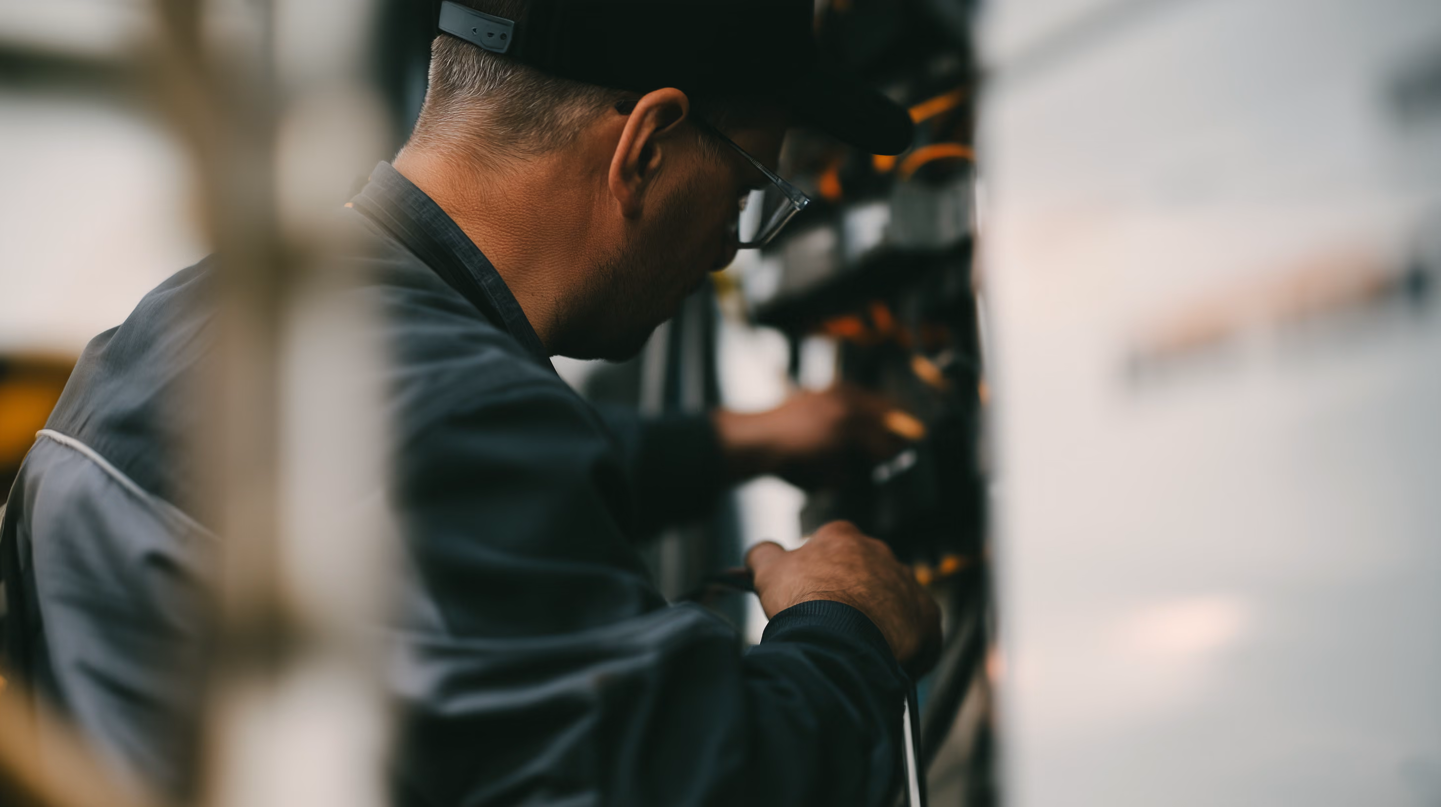 A technician working at an open equipment cabinet.
