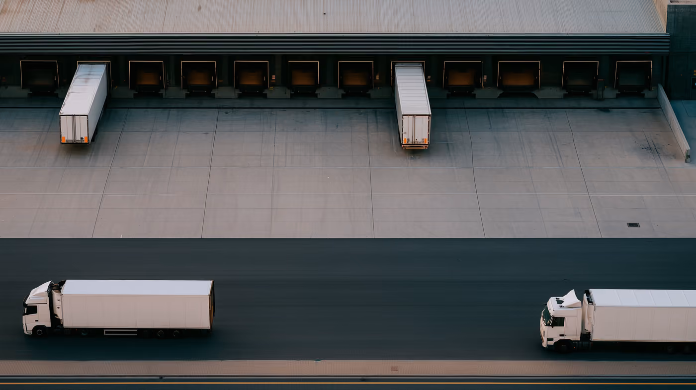 An aerial view of trailers at the loading bays of a distribution terminal.